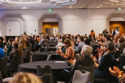Attendees conversing in a bright lobby space
